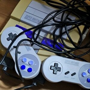 Super Nintendo SNES bundle that includes a console, 9 games, and two controllers